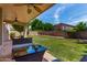 Covered patio area with manicured lawn and privacy wall perfect for relaxing outdoors at 7231 W Lone Cactus Dr, Glendale, AZ 85308