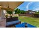 Covered patio area with outdoor seating and manicured lawn perfect for relaxing outdoors at 7231 W Lone Cactus Dr, Glendale, AZ 85308