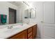Bathroom featuring double sinks, vanity with warm wood tones, and neutral countertop at 7231 W Lone Cactus Dr, Glendale, AZ 85308