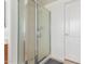 Modern bathroom with glass enclosed shower and white interior door at 7231 W Lone Cactus Dr, Glendale, AZ 85308