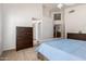 Large bedroom features neutral colors, vaulted ceiling, and ensuite bathroom at 7231 W Lone Cactus Dr, Glendale, AZ 85308