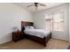 Comfortable bedroom with ceiling fan, side table, and natural light from the window at 7231 W Lone Cactus Dr, Glendale, AZ 85308
