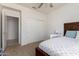 Cozy bedroom featuring a closet, ceiling fan, and easy access to the ensuite at 7231 W Lone Cactus Dr, Glendale, AZ 85308