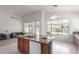Bright kitchen boasts an island with granite countertops, and opens up to the living room at 7231 W Lone Cactus Dr, Glendale, AZ 85308