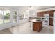 Bright kitchen features an island with bar seating, stainless appliances, and an exterior door at 7231 W Lone Cactus Dr, Glendale, AZ 85308