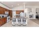 Open kitchen with granite countertops, an island with bar seating, and wooden cabinetry providing ample storage at 7231 W Lone Cactus Dr, Glendale, AZ 85308