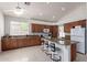 Well-lit kitchen with granite countertops, a large island with bar stools, and plenty of cabinet space at 7231 W Lone Cactus Dr, Glendale, AZ 85308