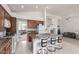 Open kitchen with granite countertops, a central island with bar seating, and seamless flow to the living area at 7231 W Lone Cactus Dr, Glendale, AZ 85308