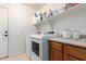 Laundry room featuring modern washer and dryer, shelving, and storage solutions at 7231 W Lone Cactus Dr, Glendale, AZ 85308