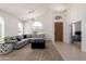 Bright living room boasts high ceilings, plush carpet, a comfortable sectional, and lots of natural light at 7231 W Lone Cactus Dr, Glendale, AZ 85308