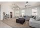 Spacious living room featuring vaulted ceilings, a comfortable sectional, and large windows for ample light at 7231 W Lone Cactus Dr, Glendale, AZ 85308