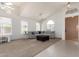 Bright and airy living room with a comfortable sectional sofa, high ceilings, and large windows for natural light at 7231 W Lone Cactus Dr, Glendale, AZ 85308