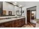Bathroom featuring dual vanity sinks, a large mirror, and access to a private toilet and shower at 7272 E Gainey Ranch Rd # 29, Scottsdale, AZ 85258