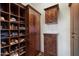 Walk-in closet featuring custom wood shelves and cabinets for ample storage at 7272 E Gainey Ranch Rd # 29, Scottsdale, AZ 85258