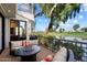 Outdoor deck with a seating area and a view of the golf course and pond at 7272 E Gainey Ranch Rd # 29, Scottsdale, AZ 85258