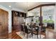 Elegant dining room with golf course views, wood floors, and custom built-in cabinets at 7272 E Gainey Ranch Rd # 29, Scottsdale, AZ 85258