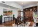 Dining room featuring wooden floors, a display cabinet, and an adjacent breakfast bar area at 7272 E Gainey Ranch Rd # 29, Scottsdale, AZ 85258