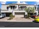 Inviting home exterior with well-manicured landscaping, garages, and driveway at 7272 E Gainey Ranch Rd # 29, Scottsdale, AZ 85258