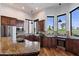 Gourmet kitchen with wooden cabinets, granite counters, stainless steel appliances, and golf course views at 7272 E Gainey Ranch Rd # 29, Scottsdale, AZ 85258