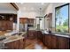Spacious kitchen featuring wood cabinets, granite counters, stainless steel appliances, and golf course view at 7272 E Gainey Ranch Rd # 29, Scottsdale, AZ 85258