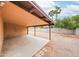 Backyard patio area showcasing the gravel landscape, block fence, and fruit tree view at 7439 E Ed Rice Ave, Mesa, AZ 85208