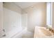 Bathroom featuring a bathtub with shower, a white vanity, and ample lighting from a window at 7439 E Ed Rice Ave, Mesa, AZ 85208