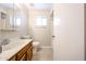 The bathroom features a wood vanity, tile floors, and a shower/tub combo at 7439 E Ed Rice Ave, Mesa, AZ 85208
