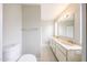 Well-lit bathroom featuring dual sinks, vanity, and toilet at 7439 E Ed Rice Ave, Mesa, AZ 85208