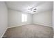 The bedroom has a ceiling fan, carpet floors, and a window for natural light at 7439 E Ed Rice Ave, Mesa, AZ 85208