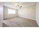 Spacious bedroom with neutral carpet, ceiling fan, and a bright window for natural light at 7439 E Ed Rice Ave, Mesa, AZ 85208