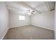 Bedroom features a ceiling fan, neutral colored walls, carpet flooring, and a large window at 7439 E Ed Rice Ave, Mesa, AZ 85208