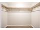 Empty walk-in closet offering ample storage space with shelving and hanging rods at 7439 E Ed Rice Ave, Mesa, AZ 85208