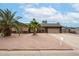 Inviting single-story home with desert landscaping, a well-kept yard and a charming mailbox at 7439 E Ed Rice Ave, Mesa, AZ 85208