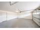 Spacious garage featuring concrete flooring, ample room for parking and storage with attached door at 7439 E Ed Rice Ave, Mesa, AZ 85208