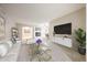 Bright living room featuring neutral tones, tile flooring, recessed lighting, and a decorative fireplace at 7439 E Ed Rice Ave, Mesa, AZ 85208