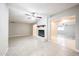 The living room with a brick fireplace, ceiling fan and archways to other rooms at 7439 E Ed Rice Ave, Mesa, AZ 85208