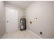 Utility room features tile flooring, water heater, and connection points against a neutral colored wall at 7439 E Ed Rice Ave, Mesa, AZ 85208