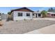 Attractive single-story home featuring a low-maintenance front yard and desert landscaping at 8002 E Whitton Ave, Scottsdale, AZ 85251