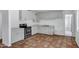 Traditional kitchen featuring stainless steel oven, white cabinets, and unique tile flooring at 8002 E Whitton Ave, Scottsdale, AZ 85251