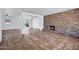 Spacious living room showcasing a striking brick fireplace and beautiful tile flooring at 8002 E Whitton Ave, Scottsdale, AZ 85251