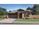 Charming single-Gathering home featuring a stone-accented facade and a well-manicured front lawn at 8048 E Paloma Ave, Mesa, AZ 85212
