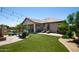 Home's landscaped backyard features string lights, a covered patio, and an outdoor seating area at 8113 S 42Nd Dr, Laveen, AZ 85339