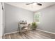 Bright bedroom with modern desk area, neutral paint, and wood-look laminate flooring at 8113 S 42Nd Dr, Laveen, AZ 85339