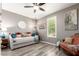 Comfortable bedroom featuring a daybed, stylish decor, and wood-look laminate flooring at 8113 S 42Nd Dr, Laveen, AZ 85339