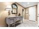 Elegant entryway showcasing a decorative table, ornate mirror, and neutral color scheme at 8113 S 42Nd Dr, Laveen, AZ 85339