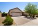 Beautiful single-story home featuring a two-car garage, neutral color palette, and a brick-paved driveway at 8113 S 42Nd Dr, Laveen, AZ 85339