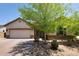 Charming single-story home featuring a lush shade tree, neutral color palette, and a brick-paved driveway at 8113 S 42Nd Dr, Laveen, AZ 85339