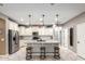 Bright, modern kitchen featuring a center island, stainless steel appliances, and ample cabinet space at 8113 S 42Nd Dr, Laveen, AZ 85339