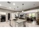 Open-concept kitchen island flows into the dining and living areas, creating an inviting space at 8113 S 42Nd Dr, Laveen, AZ 85339
