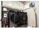Laundry room equipped with appliances, storage cabinets, and built in organization at 8113 S 42Nd Dr, Laveen, AZ 85339